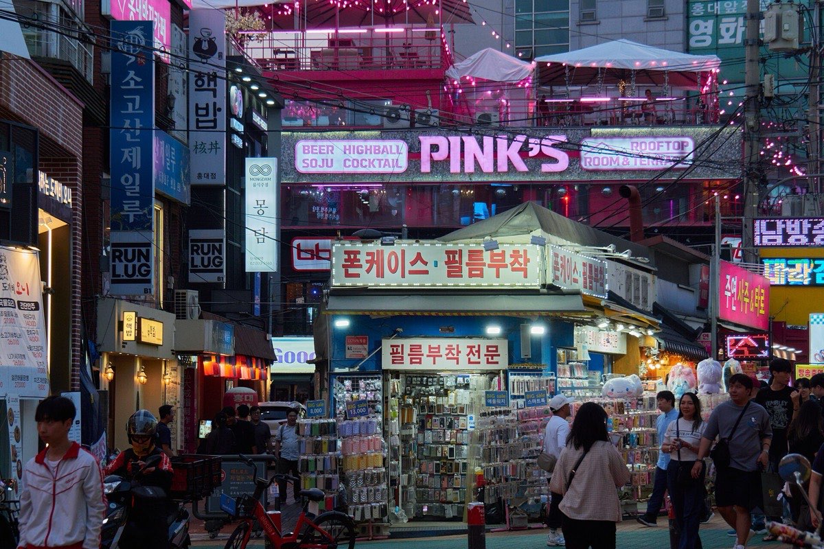 Hongdae street lined with neon-signed shops