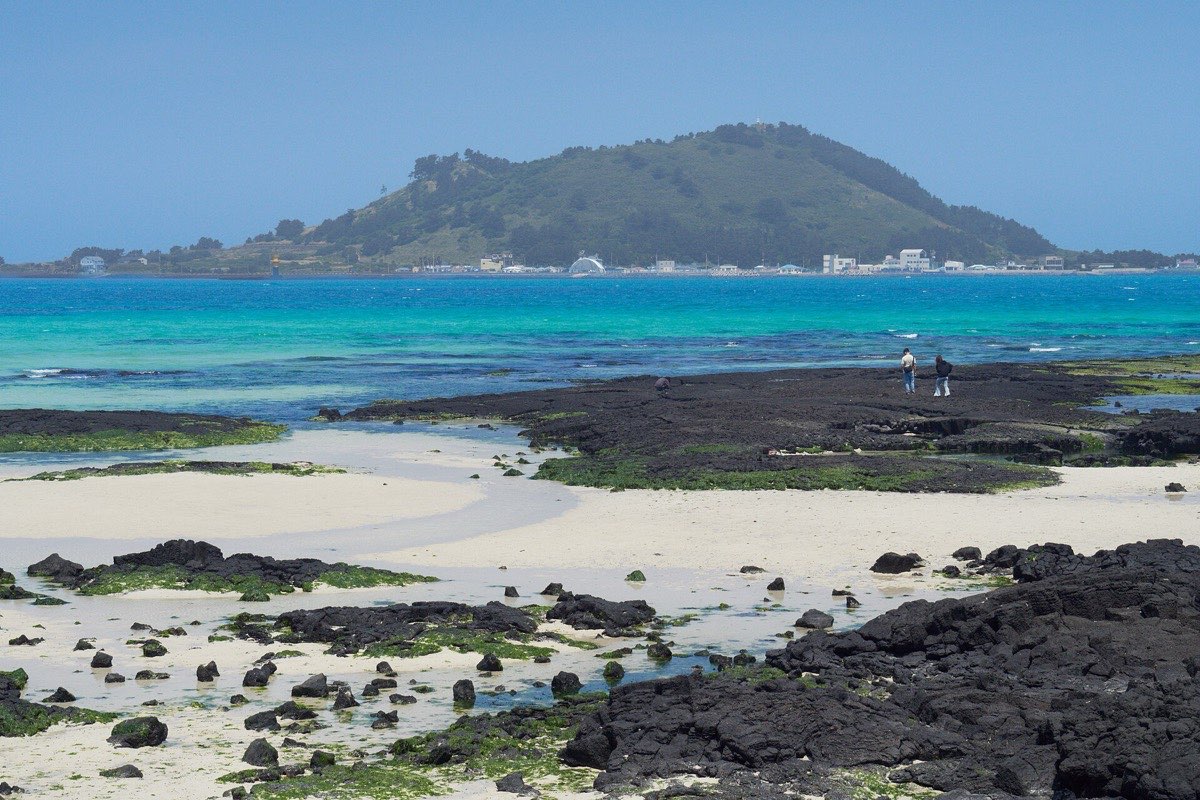 Turquoise water and black volcanic rock on Jeju's west coast
